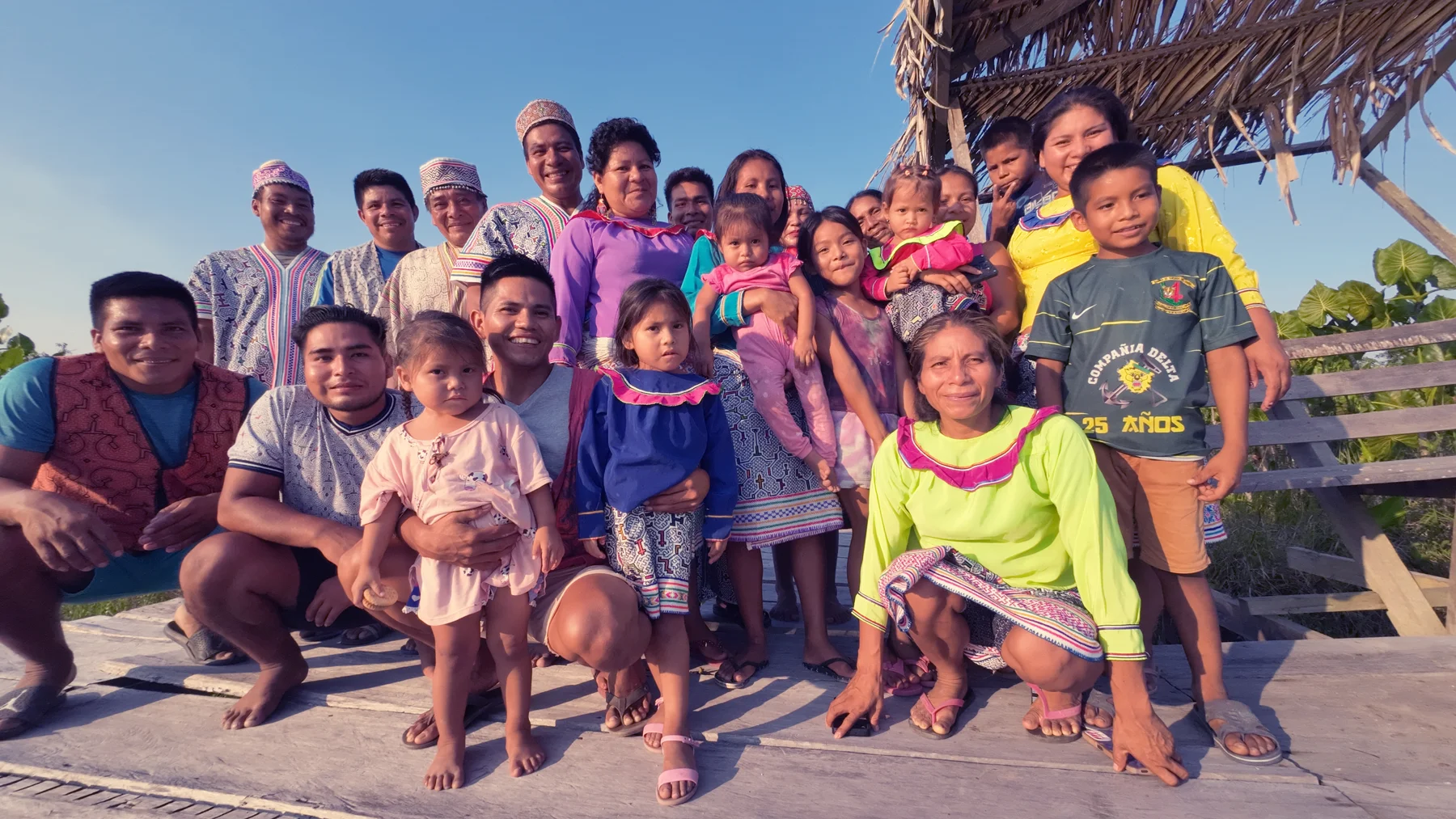 Adults and children together on a wooden platform
